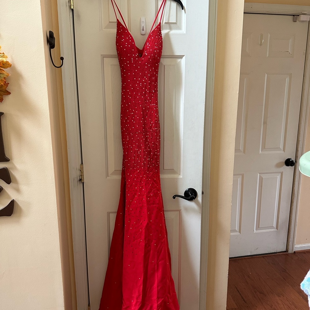 Flared red rhinestone Vneck sleeveless prom gown with sweeping train